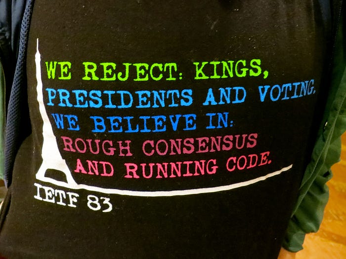 IETF 83 T-shirt printed with the motto ‘We reject: kings, presidents and voting. We believe in: rough consensus and running code.’
